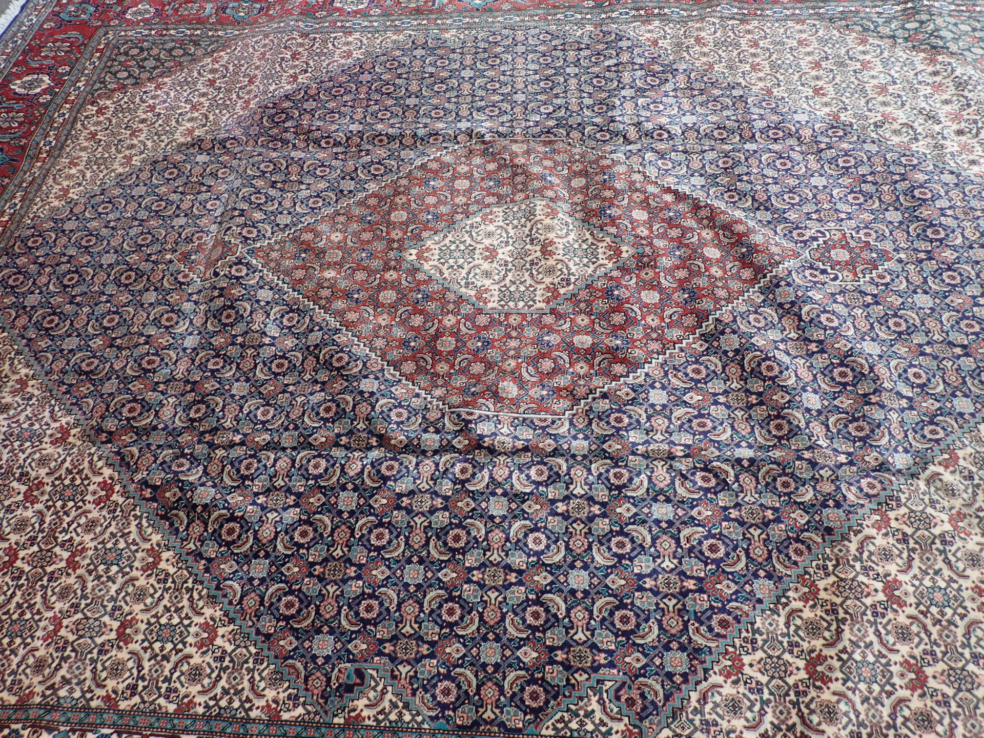 A Tabriz rug, with an all over geometric design of medallions, scrolls, roundels, on a navy ground w - Image 2 of 4