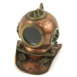 A miniature copper and brass ornamental diving helmet, 17cm high.