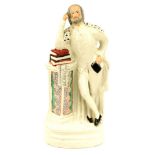 A 19thC Staffordshire flat back figure, depicting William Shakespeare, on stepped base leaning on bo