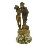 An early 20thC brass figure group, depicting nude female feeding warrior, on plinth with a green mot