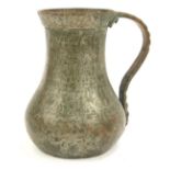 A Middle Eastern silvered copper mug, with a fluted and reeded border, with hammered handle, on a st