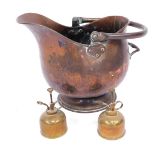 A copper coal scuttle, with swing handle, and two brass grease guns, the bucket, 31cm high. (3)