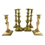 Three pairs of brass candlesticks, 20cm, 26cm and 26cm high. (3)
