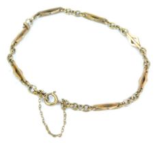 A small 9ct gold bracelet, the plain links interspersed with long lozenge shaped bar links, and with