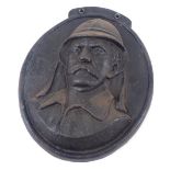 A cast oval metal wall plaque, of a military gentleman, 31cm x 25cm.