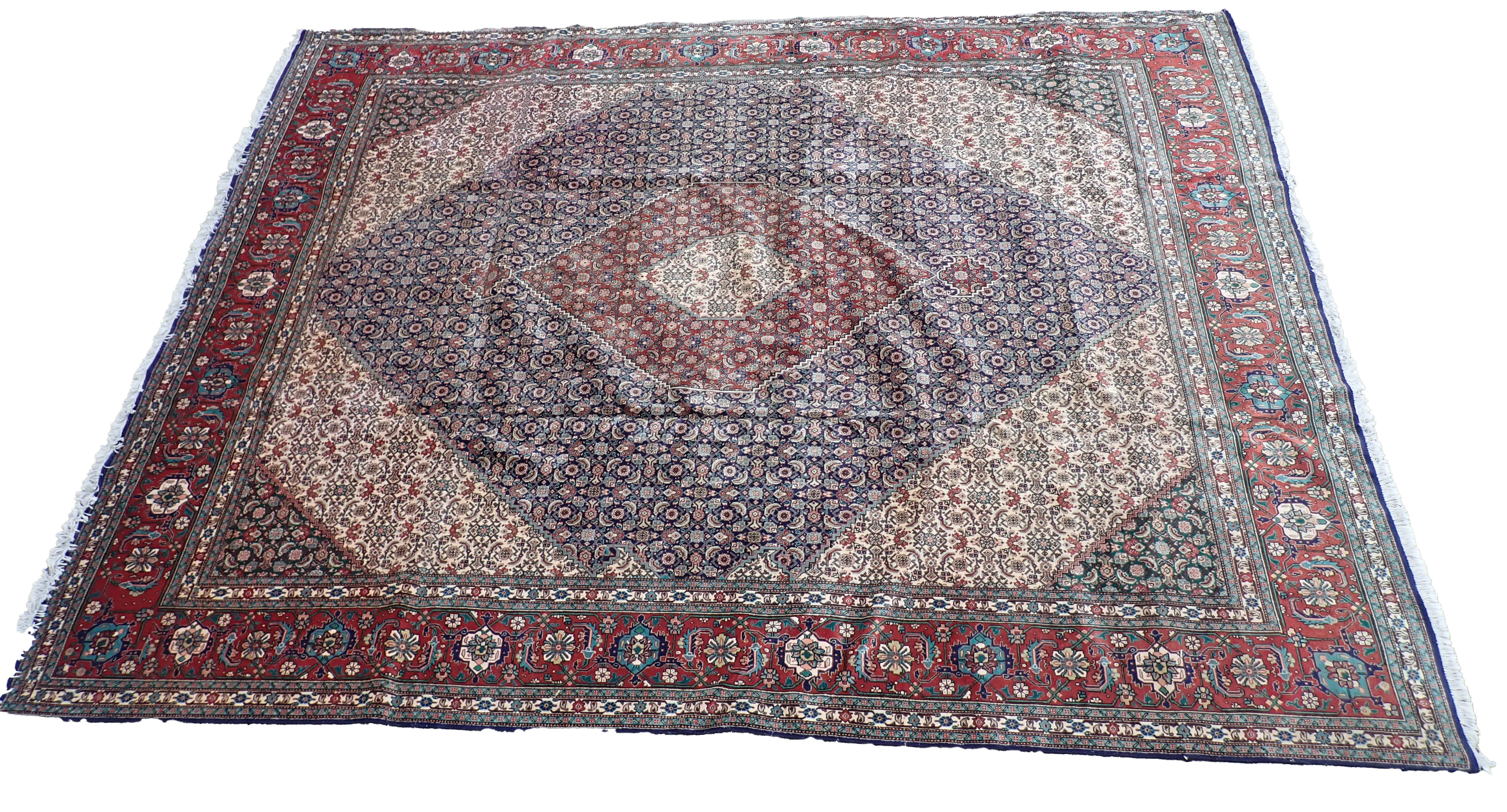 A Tabriz rug, with an all over geometric design of medallions, scrolls, roundels, on a navy ground w