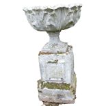 A reconstituted stone planter, the circular fluted bowl on a columned base, 89cm high, 52cm wide.