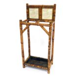 A Victorian bamboo stick and umbrella stand, with a later tile back and metal drip tray, 87cm high,