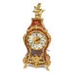 A French Louis XV style mantel clock, with hour glass shape, with gilt applied spandrels on a painte