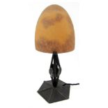 A Daum style table lamp, with a domed orange mottled glass shade, on a metal leaf moulded base, 29cm