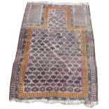 An Afghan pink ground prayer rug, the mihrab filled with geometric motifs, within repeating geometri