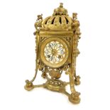 An early 20thC French brass mantel clock, with rococo scroll casing, with crown top, with dragon bor