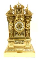 A French gilt brass mantel clock, the case decorated with swags, pillars and cherubs, above circular