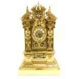 A French gilt brass mantel clock, the case decorated with swags, pillars and cherubs, above circular