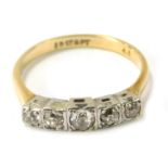 An Art Deco dress ring, with five stone set panel with round brilliant cut diamonds, in illusion set