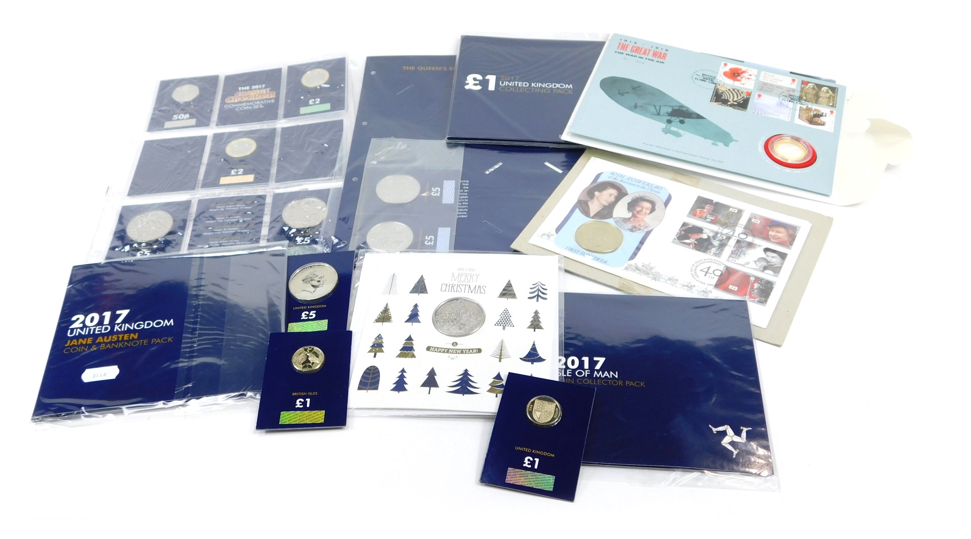 A group of collector's coin packs, comprising Merry Christmas Christmas Tree 2017, The One Pound 201