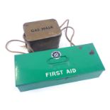 A vintage first aid tin and contents, and a brown gas mask box. (2)