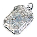A George V silver vesta case, of octagonal form with bevelled edges and engraved with flower heads a