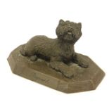 A bronzed effect figure of a seated terrier, on octagonal plinth inscribed Rupert, 17cm wide.