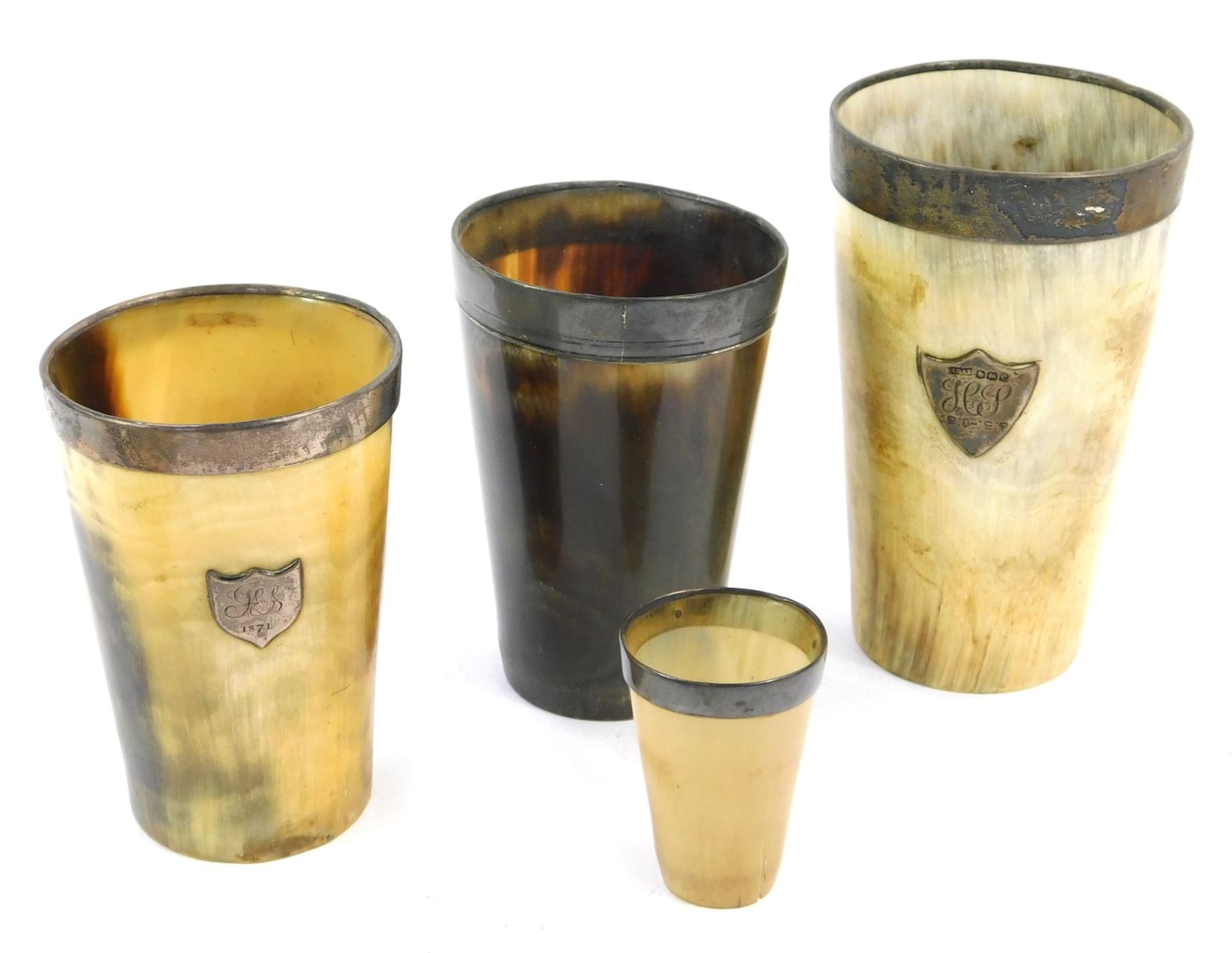 Four horn and silver rimmed beakers, two bearing crest for H J and G & H S, the largest 10cm high, t