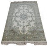 A Belgium Super Kashan cream ground rug, decorated with a central floral motif, further flowers and