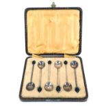 A cased set of six silver plated coffee bean spoons.