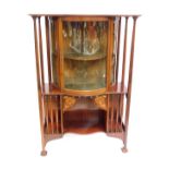 A Victorian Art Nouveau mahogany and floral inlaid bow front display cabinet, the pediment over slen