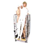 A group of mannequins, comprising four full height mannequins, various parts, torso, etc. (1 cage)