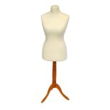 A 20thC mannequin, raised on a turned pine column over three cabriole legs, 136cm high.