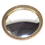 An Asonfa gilt framed concave circular wall mirror, with a fluted border and green painted cross hat