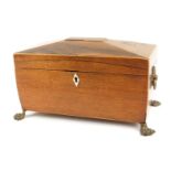 A 19thC rosewood tea caddy, with a domed top, brass lion mask handles on claw feet, lacking bowl, 19