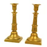 A pair of brass candlesticks, of tapered form, 26cm high.