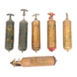 Six fire extinguishers, comprising two unmarked brass examples, three painted green examples, one wi