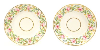 A pair of early 19thC Derby cabinet plates, with a gilt border with painted rose decoration and cent