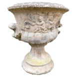 A reconstituted stone garden urn, with a fluted top with moulded handles, 63cm high, 60cm wide. (AF)