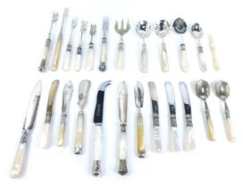 An assortment of Victorian and later mother of pearl handled serving implements, to include two silv
