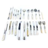 An assortment of Victorian and later mother of pearl handled serving implements, to include two silv