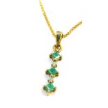A 9ct gold emerald and diamond pendant and chain, the pendant set with three square cut emeralds and