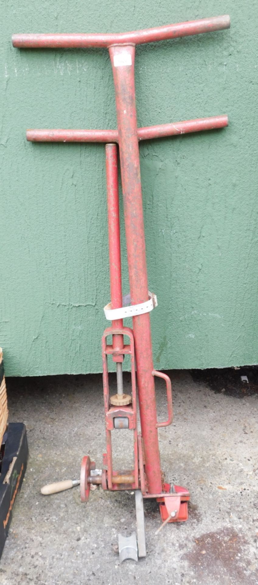 A red metal trolley jack.