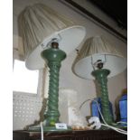A pair of green painted twist stem table lamps with shades, together with a cream silk damask lamp s
