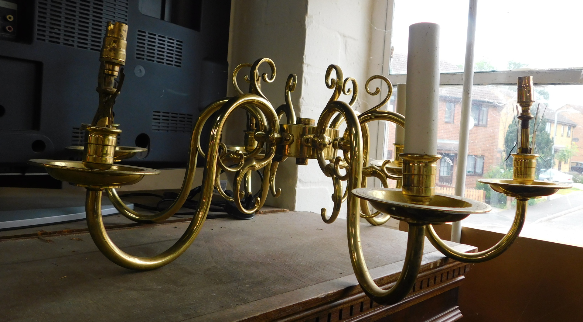 A brass six branch handing chandelier, 22cm high, lacking central hanging fitment.