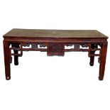 A Chinese table, with carved frieze, 85cm high, 188cm wide, 77cm deep.