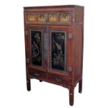 A Chinese red and black lacquer cabinet, with gilt fret work carved panels, over two aesthetic carve