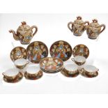 A Taisho period Japanese Kutani porcelain tea set, decorated with dragons in relief and reserves of