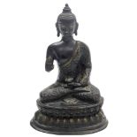 A bronze figure of Buddha, seated in padmasana pose on a lotus bed, 25cm high.