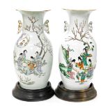 A near pair of late 19thC Qing Dynasty porcelain vases, of twin handled ovoid form, decorated with f