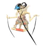 An Indonesian Wayang Kulit leather shadow puppet, modelled as a figure with a blue painted face, wit