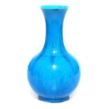 A Chinese porcelain turquoise glazed vase, of bottle form with a flared neck, incised with flowers a