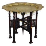 A Chinese pierced brass shaped tray top table, with hardwood folding six leg stand, 53cm high, 82cm