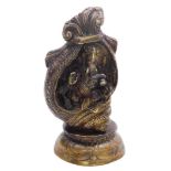 A bronze figure modelled as the Hindu god Ganesha, seated in a conch shell set on a lotus flower, 21